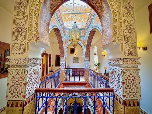 a hallway with a staircase in a building with a ceiling at Riad Al-Qurtubi in Tangier