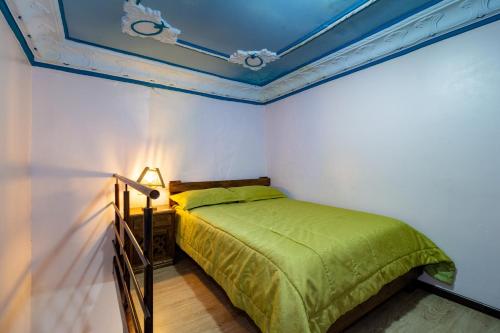 Ένα ή περισσότερα κρεβάτια σε δωμάτιο στο Hotel Majestic 1 Centro histórico Cuenca