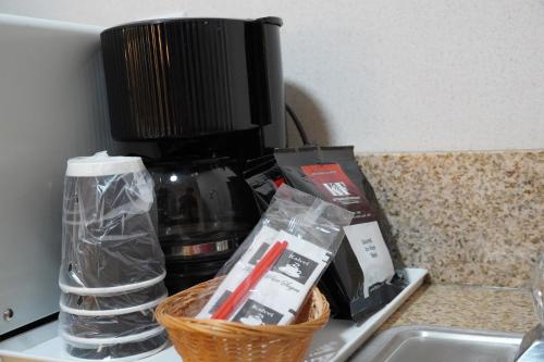 a counter with a coffee maker and a basket on it at Timberland Inn & Suites in Castle Rock