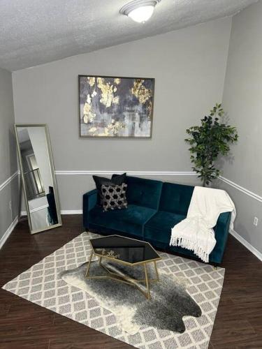 - un salon avec un canapé bleu et une table dans l'établissement 1 BR Loft Medical District Fondren, à Jackson