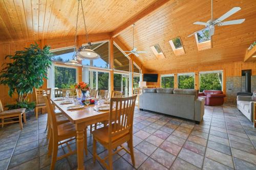 a dining room with a table and a couch at Captain's Hideaway in Nehalem