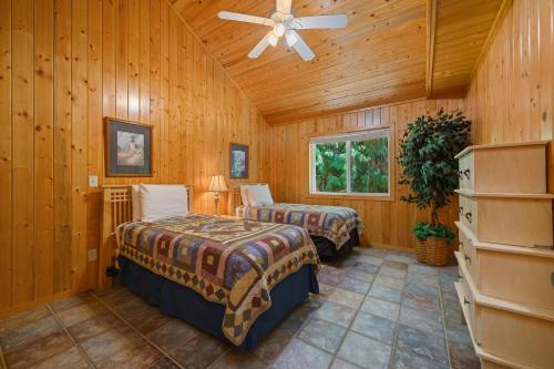 a bedroom with two beds and a ceiling fan at Captain's Hideaway in Nehalem
