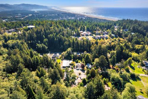 an aerial view of a house with trees and the ocean at Captain's Hideaway in Nehalem