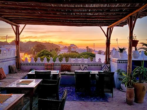 a restaurant with a view of the city at sunset at Riad Al-Qurtubi in Tangier