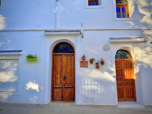 a white building with two wooden doors on it at Riad Al-Qurtubi in Tangier
