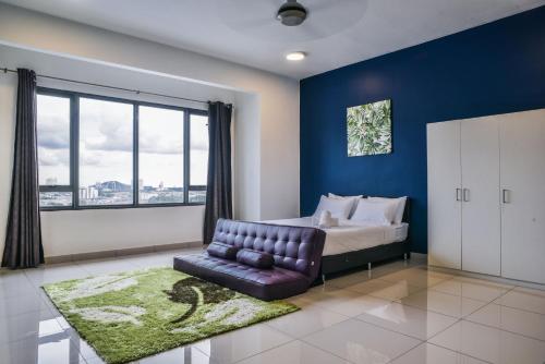 a bedroom with a bed and a couch and a window at DaMen Homestay @SubangHomeStay in Subang Jaya