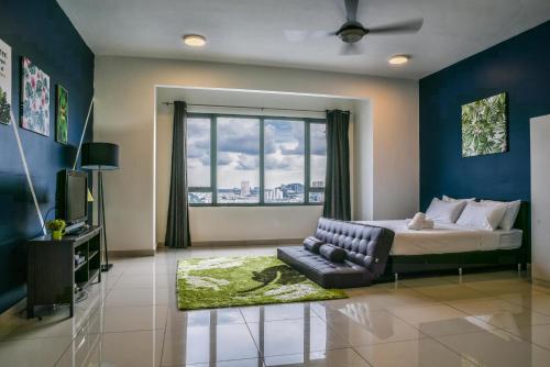 a bedroom with a bed and a couch and a window at DaMen Homestay @SubangHomeStay in Subang Jaya