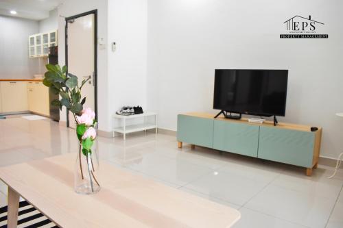 a living room with a vase of flowers on a table at DaMen Homestay @SubangHomeStay in Subang Jaya