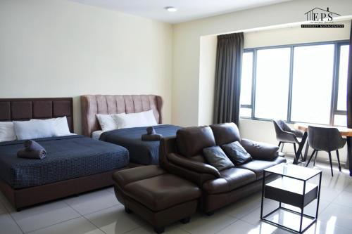 a bedroom with a bed and a couch and a chair at DaMen Homestay @SubangHomeStay in Subang Jaya