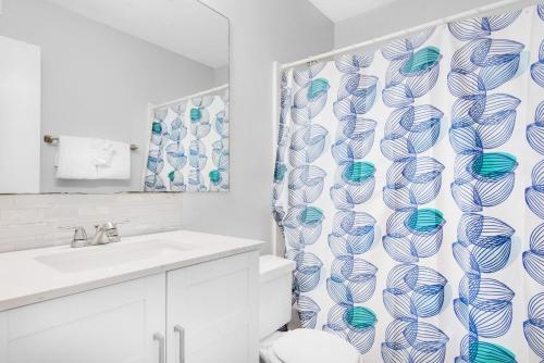 a bathroom with a toilet and a shower curtain at Sand Castles West II G6- NEW in Panama City Beach