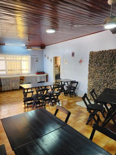 a group of tables and chairs in a room at Encantos do Lázaro in Ubatuba