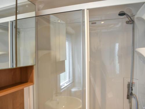 a glass shower in a bathroom with a sink at Ashness - Uk44966 in Plumbland