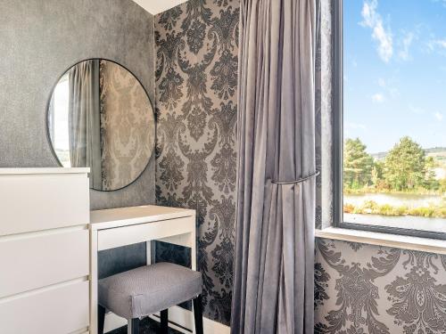 a dressing table and mirror in a room with a window at Lakeside Cottage in Lanchester