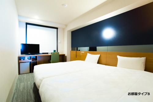 Postel nebo postele na pokoji v ubytování Hotel Meldia Kyotoshijoomiya