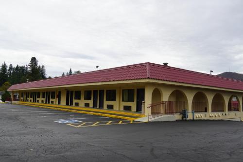 a building with a red roof in a parking lot at Timberland Inn & Suites in Castle Rock