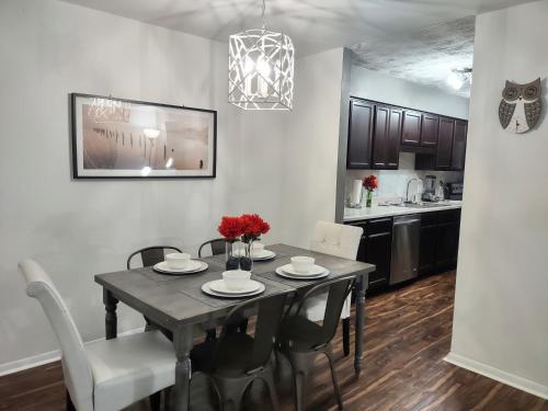 a kitchen and dining room with a table and chairs at Charming Condo in Central Raleigh in Raleigh