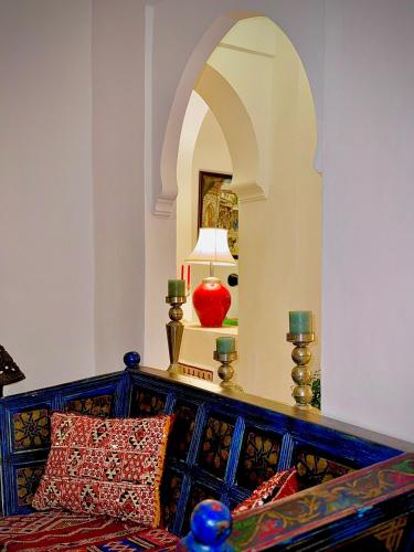 a room with a bed with a red lamp and a mirror at Riad Al-Qurtubi in Tangier