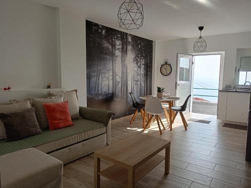 a living room with a couch and a table at La Lunita in Valverde