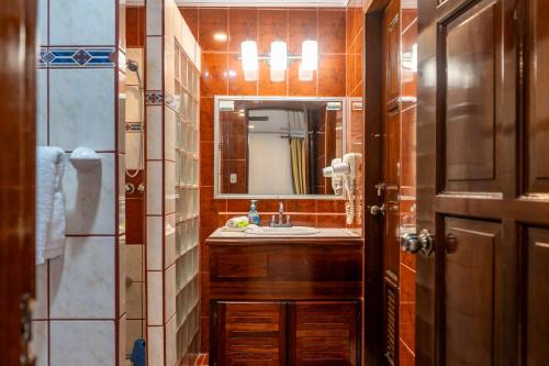 a bathroom with a sink and a mirror at Laguna Eco Village #205 Pool/ Tennis Courts/ BBQ in Quepos