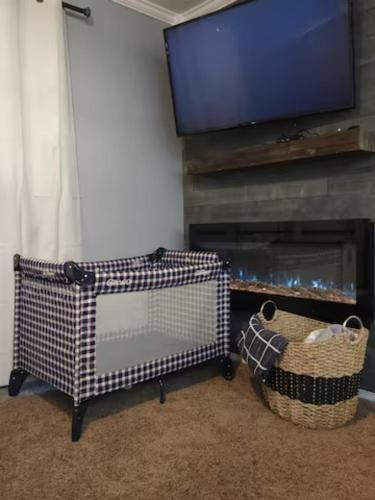 a living room with a fireplace and a flat screen tv at Cozy Lakeside Getaway - Outdoor Theater - Free Early Check-In- 4min to Silver Dollar City in Branson
