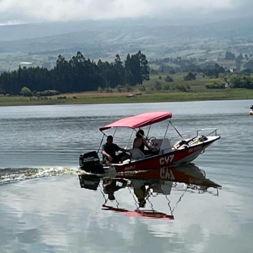 two people in a small boat on the water at Glamping Yerbabuena in Toca