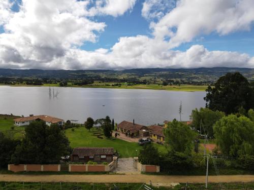 an aerial view of a house next to a lake at Glamping Yerbabuena in Toca