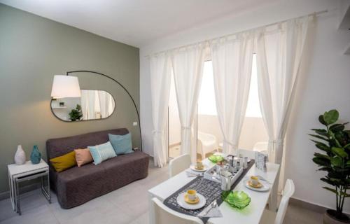 a living room with a table and a couch at Ducassi - Sol Caribe playa los corales in Punta Cana