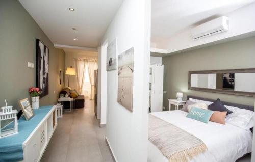 a bedroom with a large bed and a living room at Ducassi - Sol Caribe playa los corales in Punta Cana