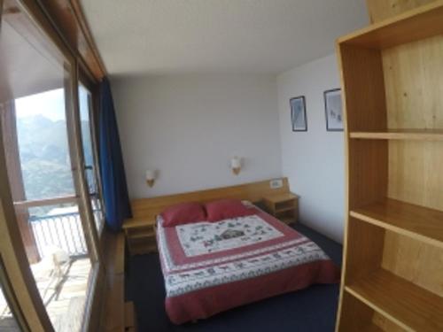 a small bedroom with a bed and a window at Appartement lumineux 60m² · 2 ch. · Balcon · WIFI · Parking - FR-1-346-557 in Arc 1800