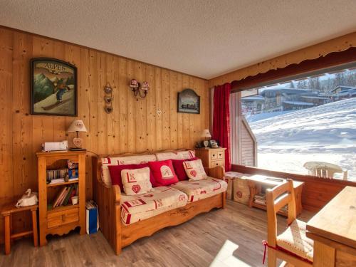 a bedroom with a bed with red pillows and a window at Appartement Morillon Village, 3 pièces, 7 personnes - FR-1-642-84 in Morillon