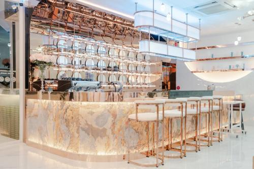 a restaurant with a marble counter and stools at Moose Hotel Chiangmai in Chiang Mai