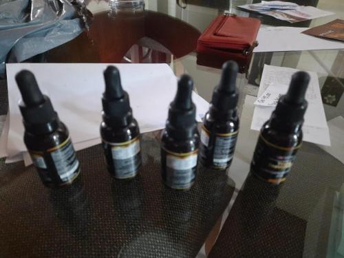three bottles of essential oils sitting on a table at Patricia in Criciúma