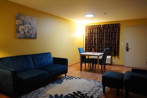a living room with a couch and a table at Timberland Inn & Suites in Castle Rock