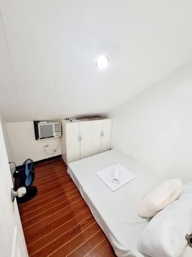 a small room with a bed and a microwave at Furnished House in Calapan City Subdivision near ROBINSONS Mall L33 in Calapan