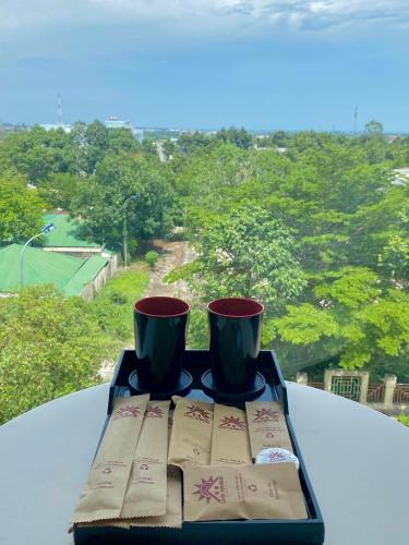 two cups sitting on a tray on a table at Lagi Sunrise Hotel in La Gi
