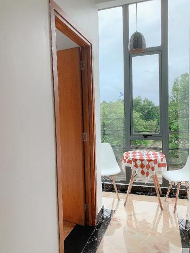 a room with a table and chairs and a window at Lagi Sunrise Hotel in La Gi