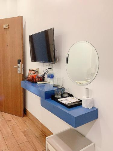 a bathroom with a blue counter with a mirror at Lagi Sunrise Hotel in La Gi
