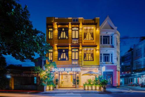 a yellow building with a sign on the front of it at Golden Sun Hotel Hoi An in Hoi An