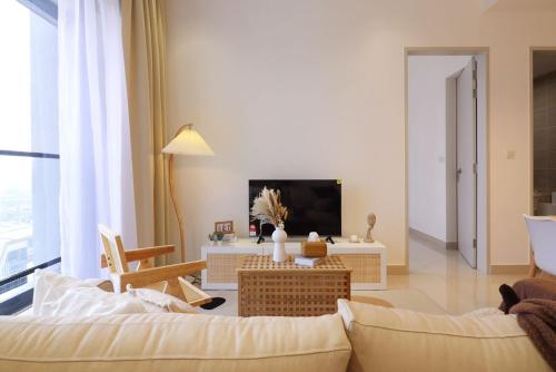 a living room with a couch and a tv at 10 min to My town family unit By Nexx Field in Kuala Lumpur