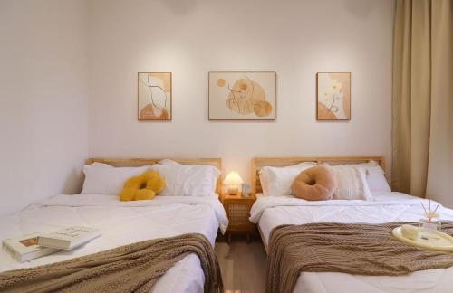 two beds with stuffed animals on them in a room at 10 min to My town family unit By Nexx Field in Kuala Lumpur