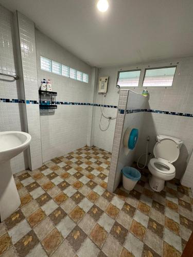 a bathroom with a toilet and a sink at SukhothaiNeeDee FarmCafe in Sukhothai