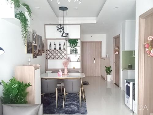 a kitchen with a table and chairs in a room at SNOW`S HOUSE in Ho Chi Minh City