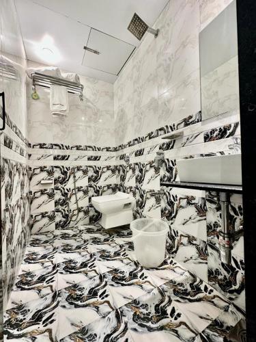 a bathroom with a black and white patterned wall at HOTEL BKC PRIME - NEAR US CONSULATE in Mumbai