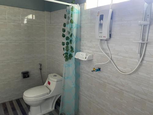 a bathroom with a toilet and a shower at มองภู โฮมสเตย์ in Ban Fang