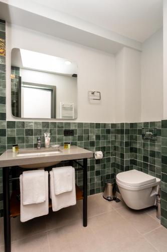 a bathroom with a sink and a toilet at Hotel Flower in Tbilisi City