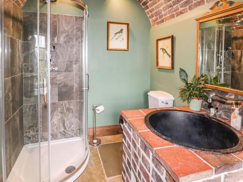 uma casa de banho com uma banheira grande e um chuveiro em Riverview Apartment em Bridgnorth