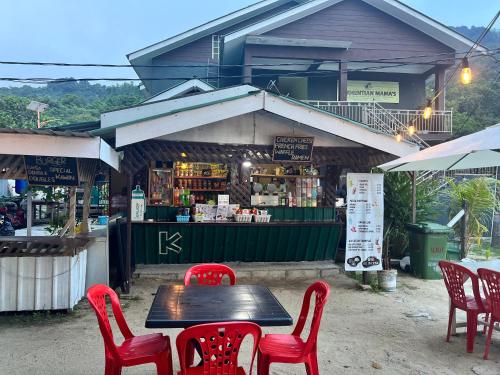 a table and chairs in front of a store at Perhentian Mama's in Perhentian Islands