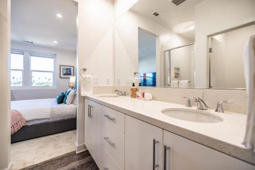 La salle de bains est pourvue d'un lavabo et d'un lit. dans l'établissement 5mins to Disney/3 Bedroom House with Pool, à Anaheim
