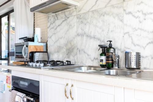 a kitchen with a sink and a counter top at Million Dollar Views in Hobart