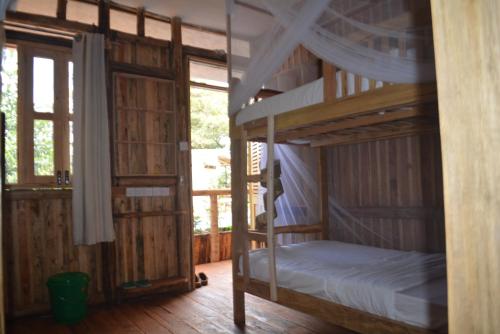 a bedroom with two bunk beds in a room at Jinja Backpackers in Jinja